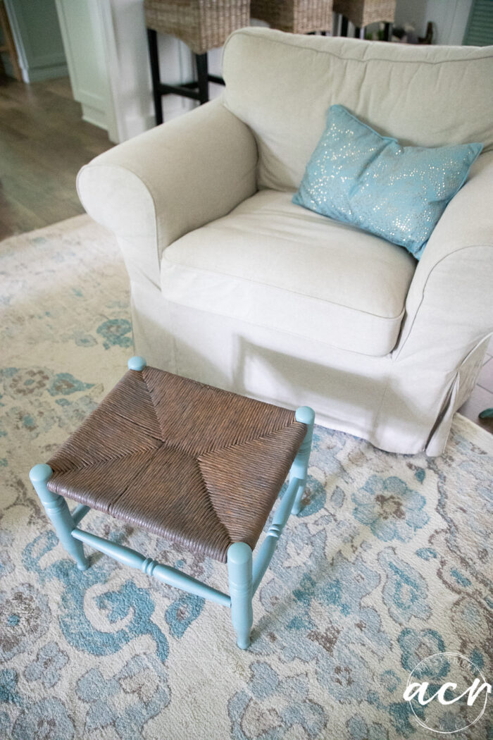 tan chair blue pillow and footstool