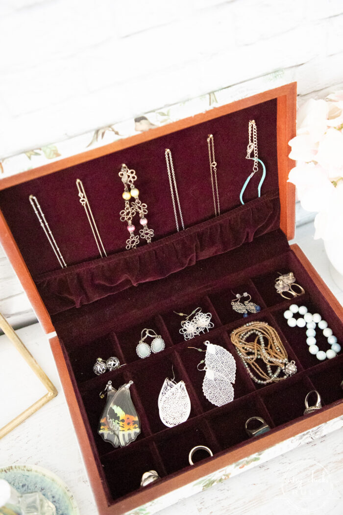 top view of open jewelry box with jewelry