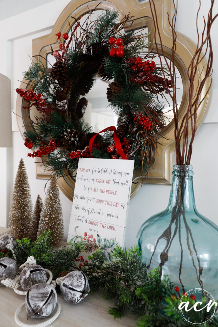 pretty Christmas display with wreath, bells, blue vase and bible verse project