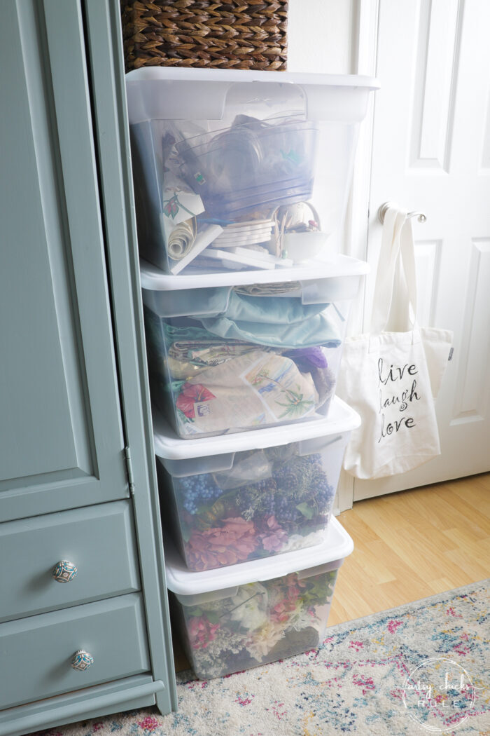 plastic bins with fabric and florals
