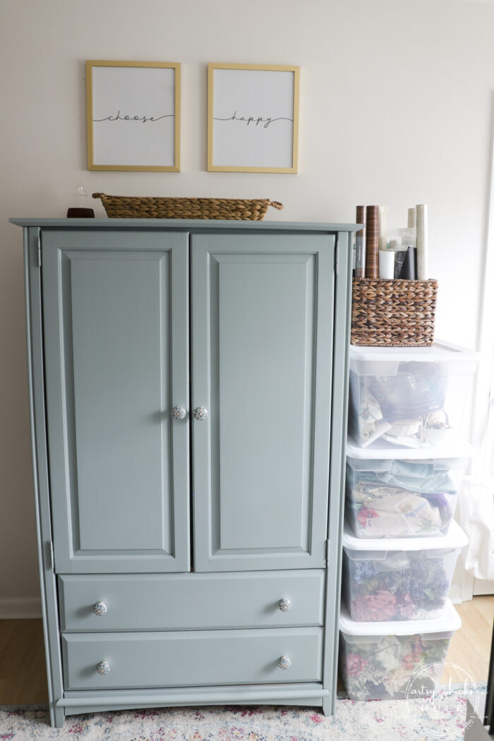 blue armoire with choose happy signs