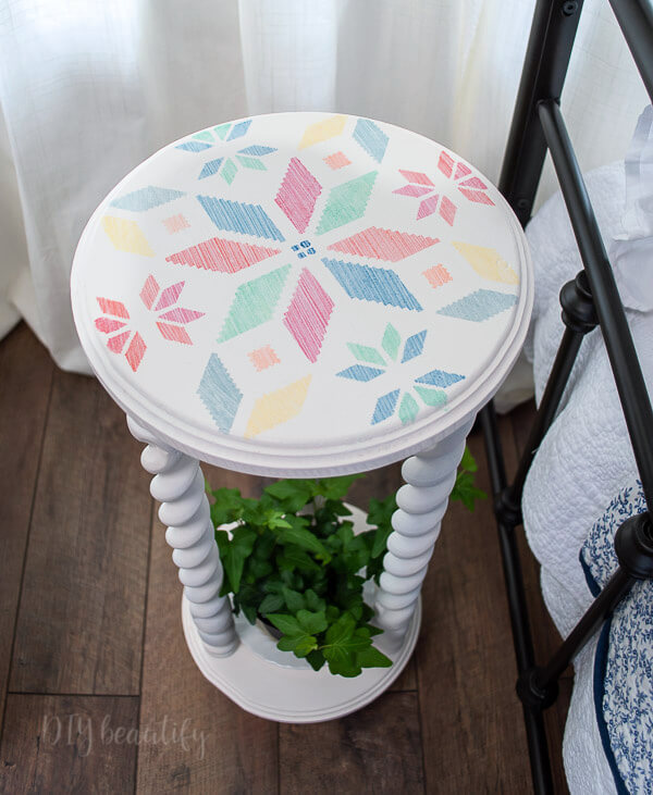 white plant stand stenciled top