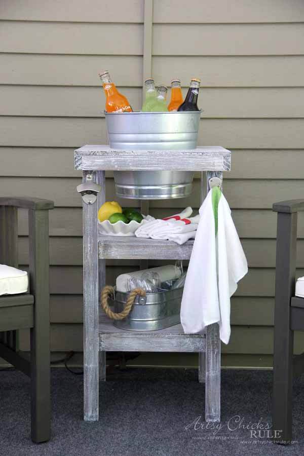 beverage stand with towel and metal bucket with drinks
