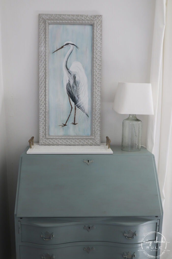 blue heron painting on blue desk with lamp