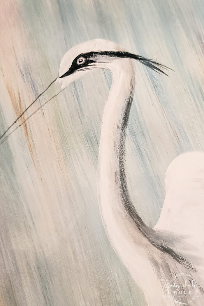 second step of painting in eye of blue heron