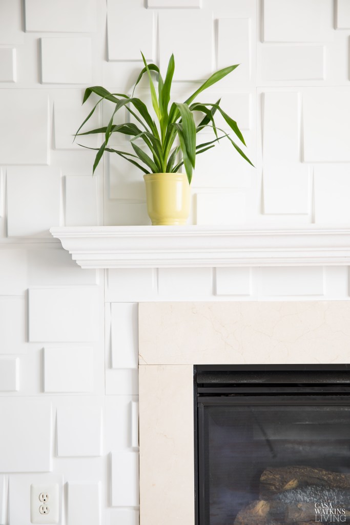 modern 3D blocks in white around fireplace with green plant on mantel