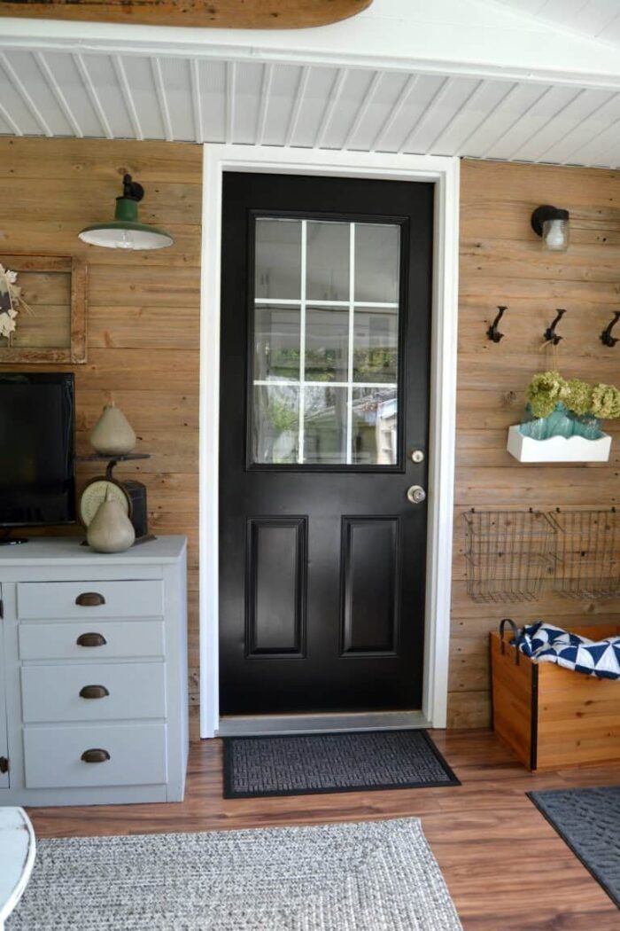 wood wall with reclaimed wood and black door