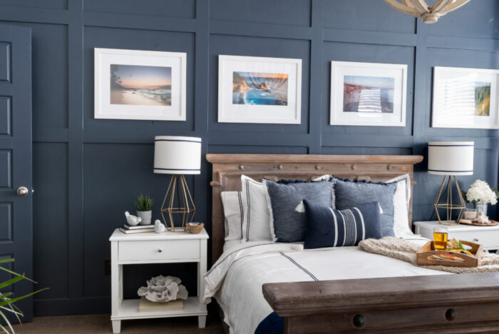 dark navy blue wall with board and batten boxes and bed, nightstands
