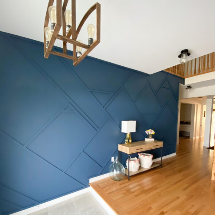 dark navy blue wall with abstract wood pattern on wall, wood floor