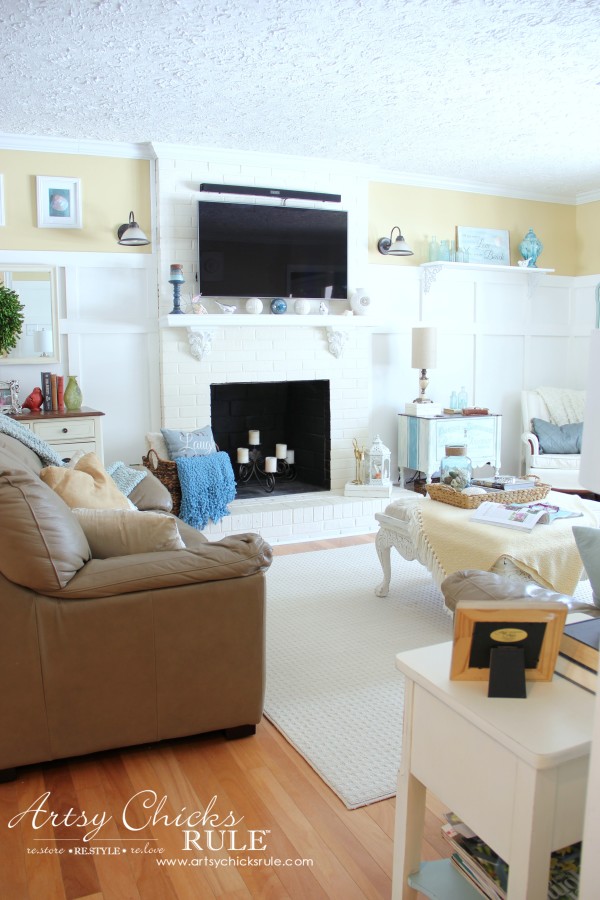 fireplace with yellow walls in living room