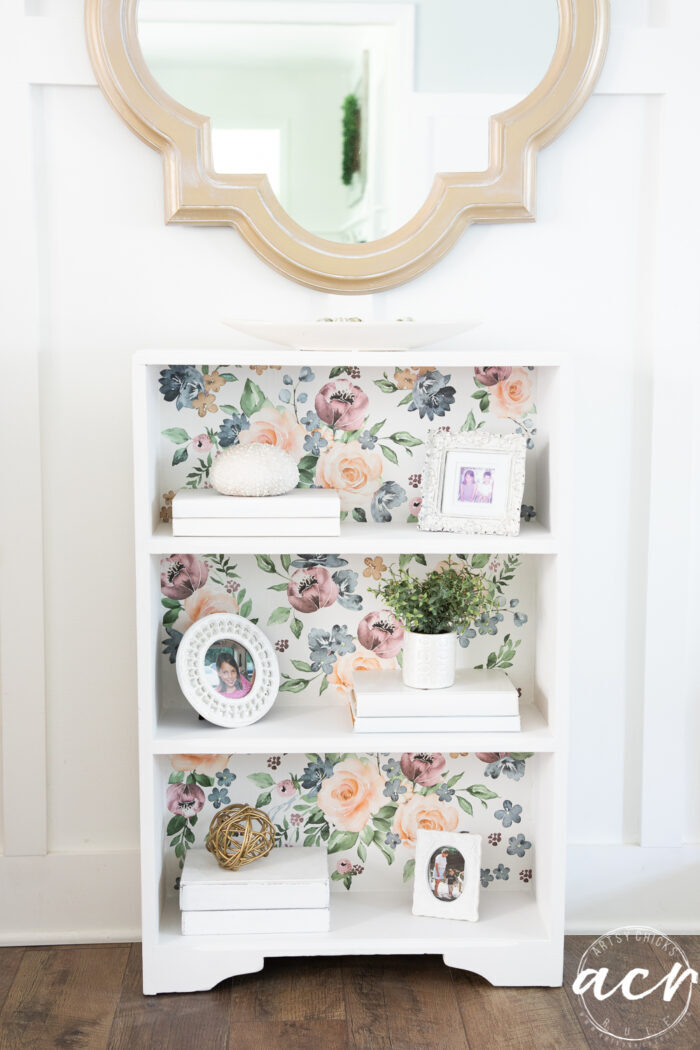 white book case with colorful floral transfer