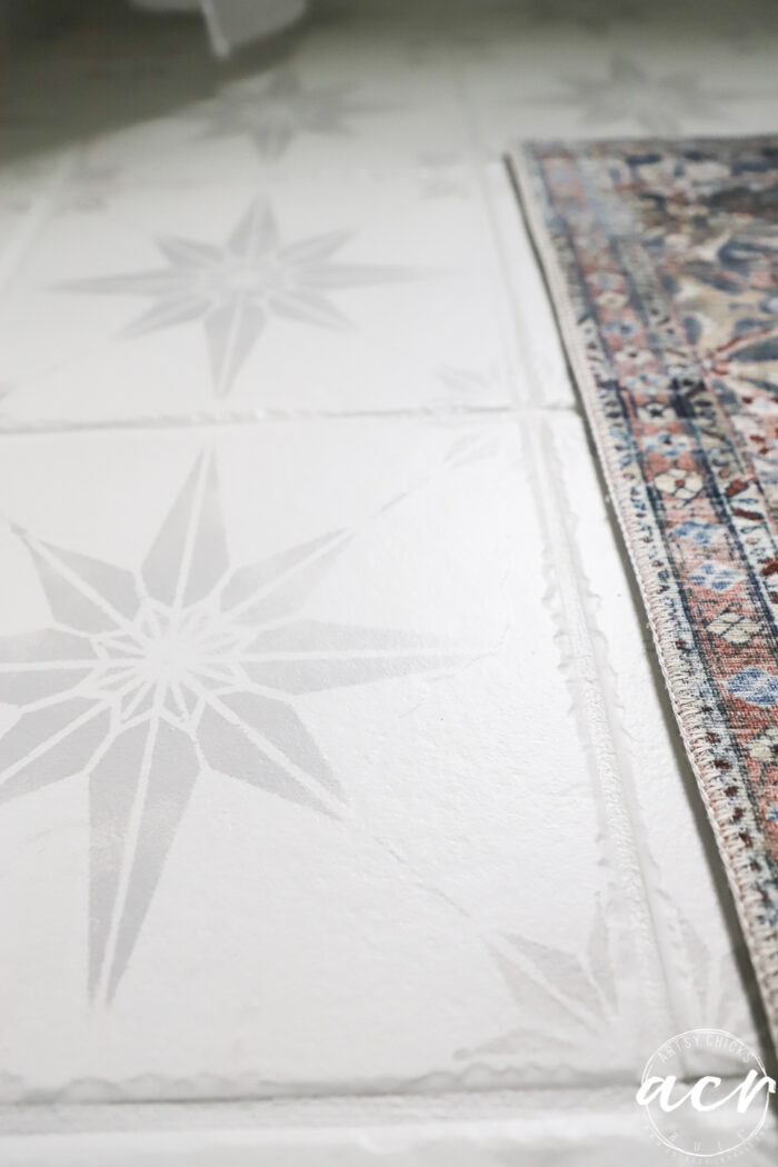 white and gray stenciled star painted tile floors