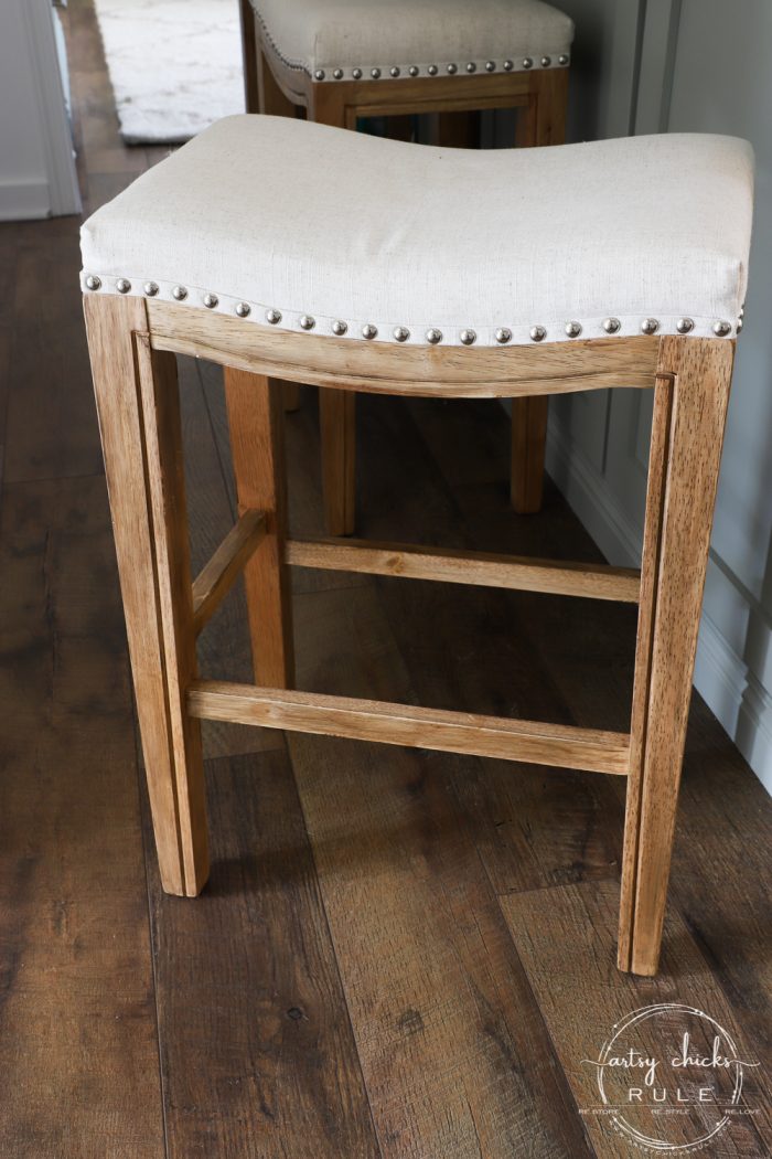 wood stained stool with beige seat