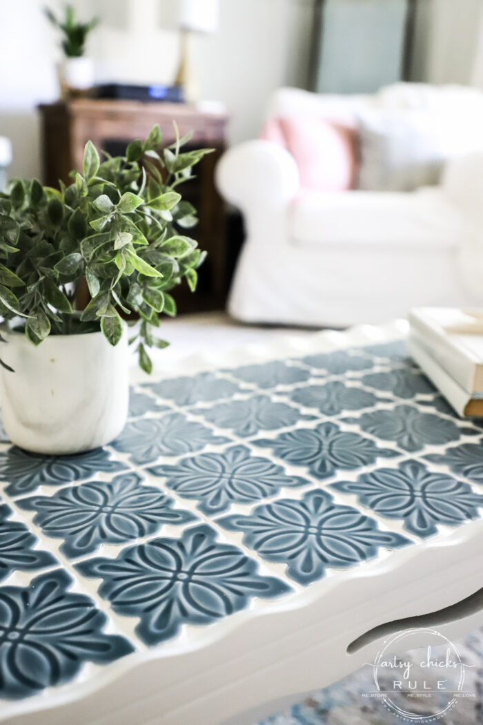 blue tiled table with green plant