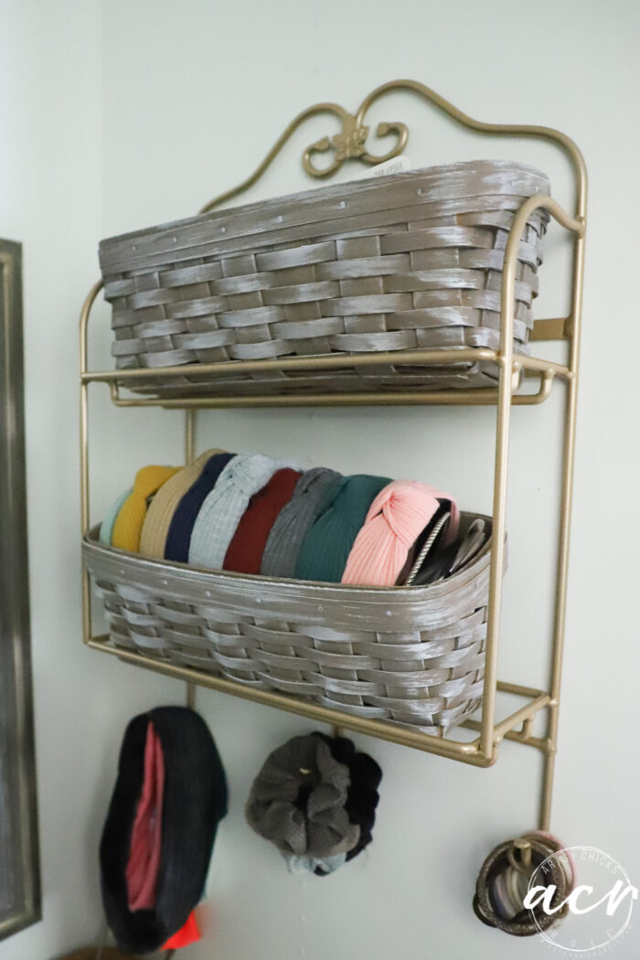 baskets on wall holding hair ties and more
