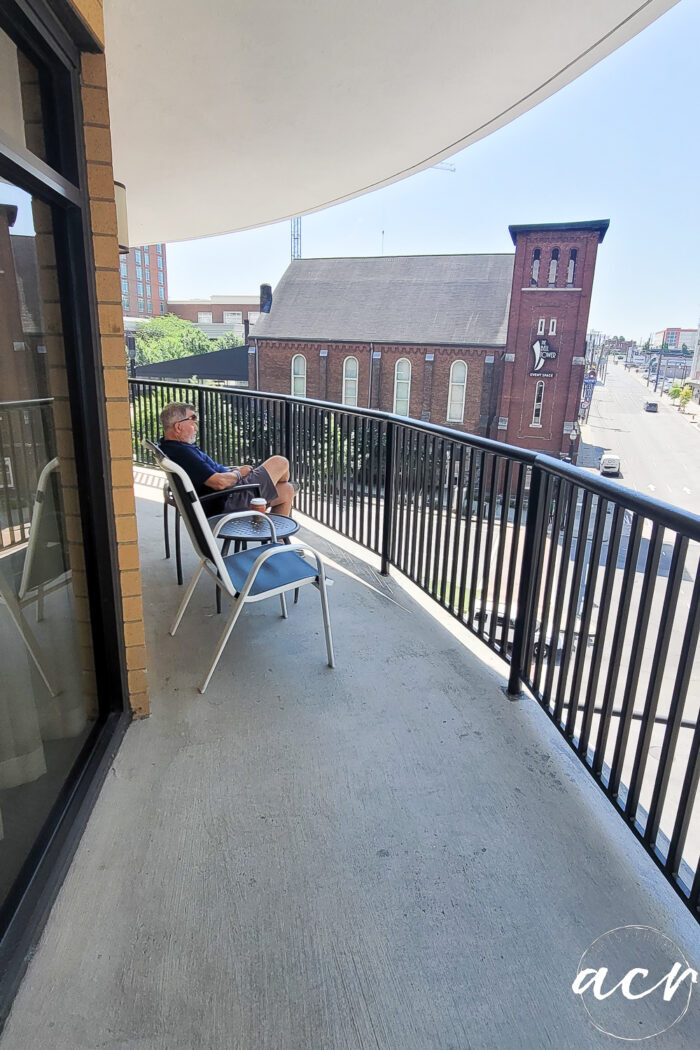 man sitting on balcony