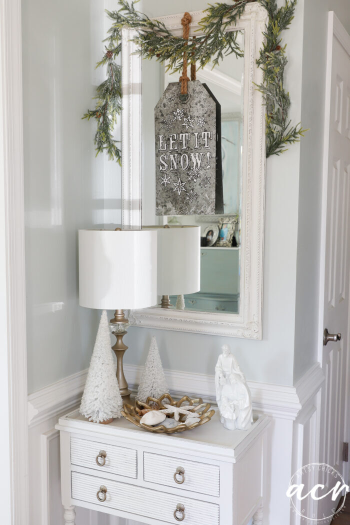 foyer mirror and white table with Christmas decor
