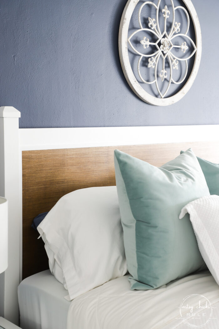 white pillows, aqua pillow and wood headboard