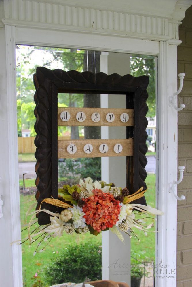 dark stained wood frame with happy fall letters and orange ivory floral arrangement on bottom