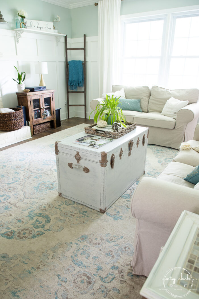 living room view with painted white trunk