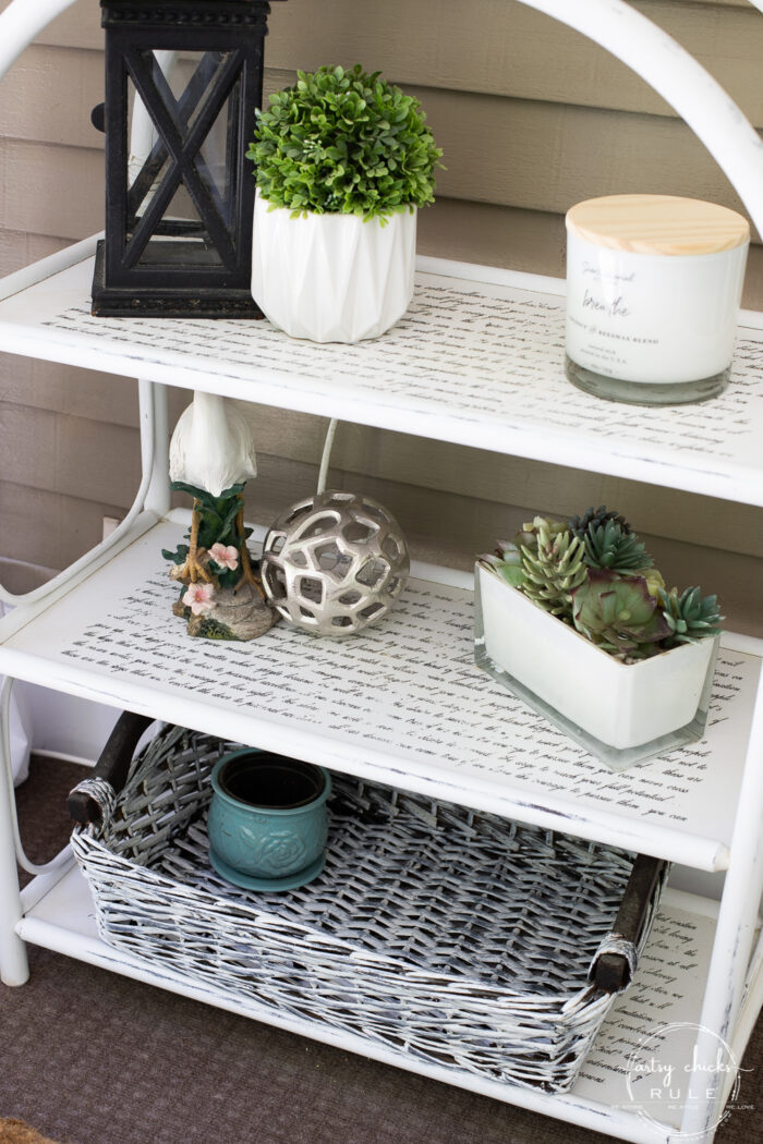 small floor shelf with various coastal decor items