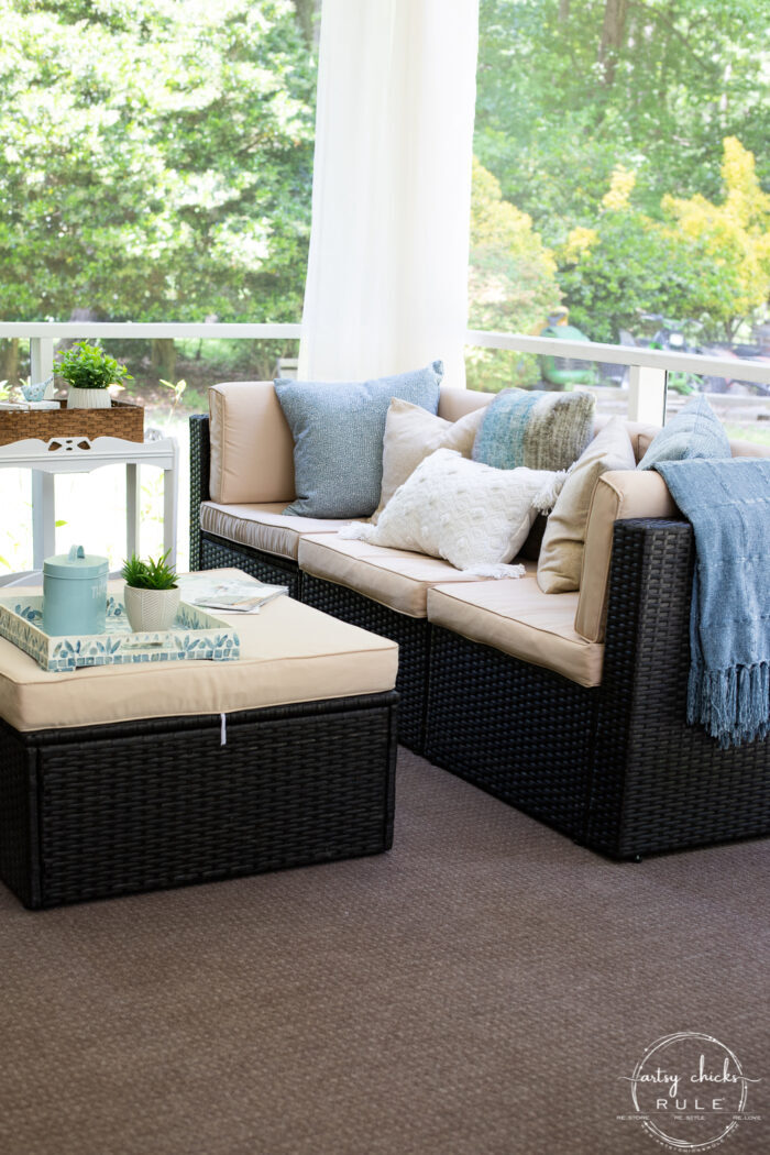 dark brown wicker patio furniture with aqua and tan pillows