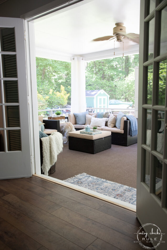 view from inside living space to out in screened porch through french doors