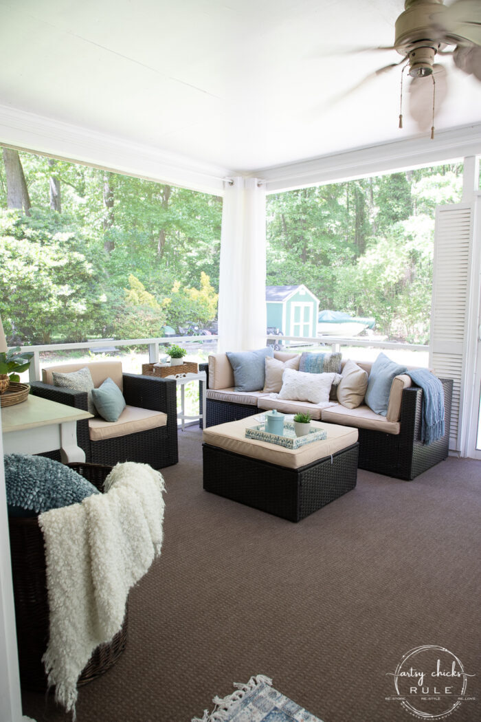 aqua and brown porch with tan pillows and brown carpet