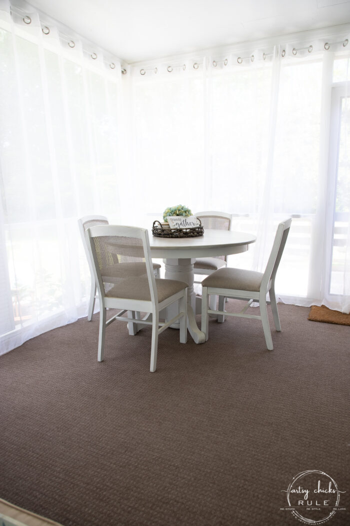 dining table with sheer curtains pulled closed