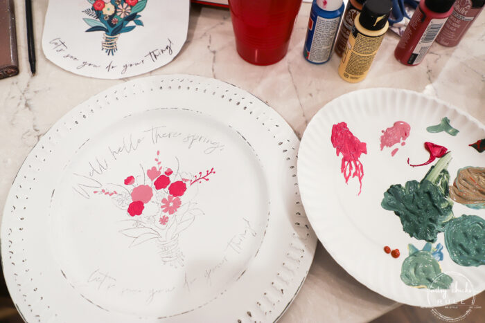 painting in the pink flowers on white plate