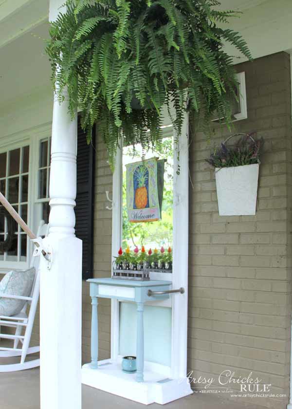 green fern on porch with blue and white hall tree